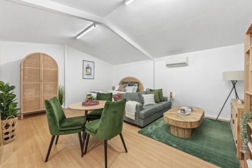 a living room with a couch and a table and chairs at • Cottage 1851 • Boutique in Brown Hill in Gong Gong