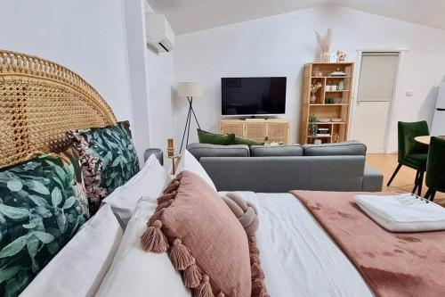 a living room with a couch and a television at • Cottage 1851 • Boutique in Brown Hill in Gong Gong