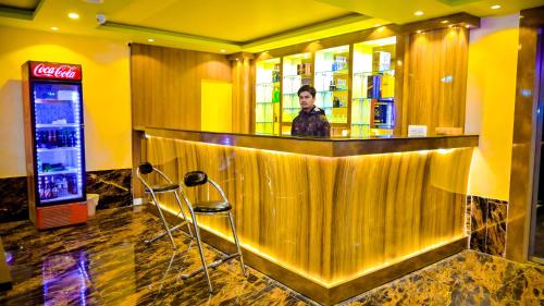 a man standing at a bar in a restaurant at HOTEL STAR HOLIDAY PVT LTD in Bhairāhawā