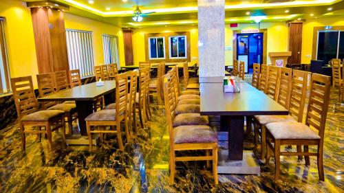 a restaurant with tables and chairs in a room at HOTEL STAR HOLIDAY PVT LTD in Bhairāhawā
