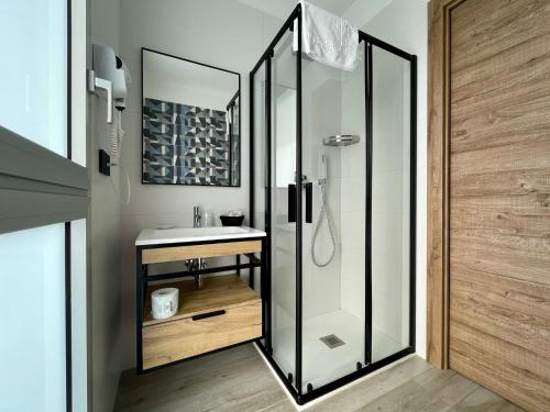 La salle de bains est pourvue d'une douche en verre et d'un lavabo. dans l'établissement Bari Airport Rooms, à Bari