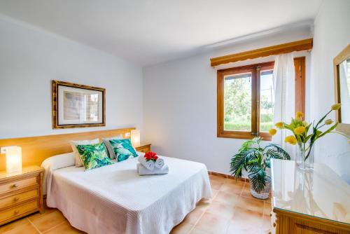 a bedroom with a bed and a window at Ideal Property Mallorca - Ca na Tonina in Port de Pollensa