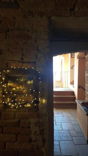 a room with a brick wall with christmas lights at Il Borgo B&B in Castellinaldo