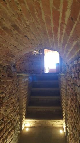 a brick tunnel with a light at the end of it at Il Borgo B&B in Castellinaldo