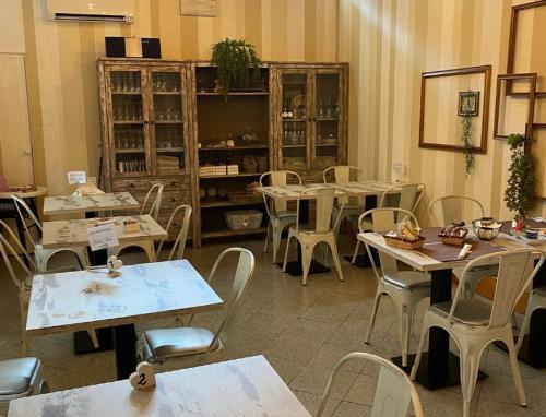 a dining room with tables and chairs and a room with tables and chairs at Hotel Nice in Viareggio