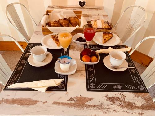 a table with breakfast foods and drinks on it at Hotel Nice in Viareggio