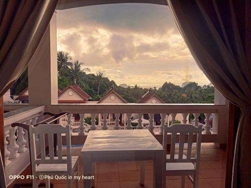 a table and chairs on a balcony with a view at Hong Bin Bungalow in Phu Quoc