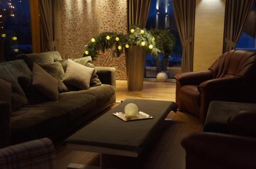 a living room with a couch and a table at Jaunkrastmaļi in Kandava