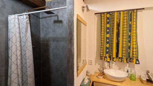 a bathroom with a shower curtain and a sink at Chajdaloupka in Košťany