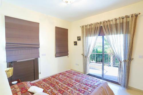 a bedroom with a bed and a large window at Villa Arbanassi in Lachi