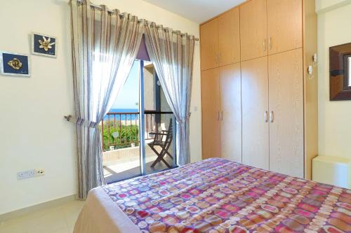 a bedroom with a bed and a view of the ocean at Villa Arbanassi in Lachi