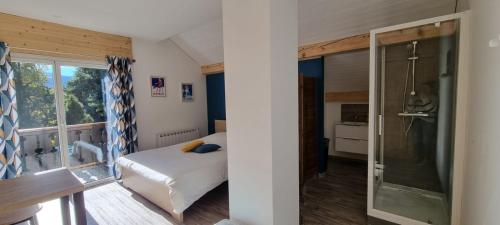 une chambre avec un lit et une douche en verre dans l'établissement Mont Bivouac, chambre,entrée et Sdb privée,balcon vue MtBlanc, à Passy