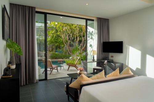 a hotel room with a bed and a view of a patio at Eightfold Urban Resort in Siem Reap