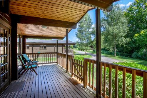a large deck with a bench on it at Willowbank Lodges in Oare