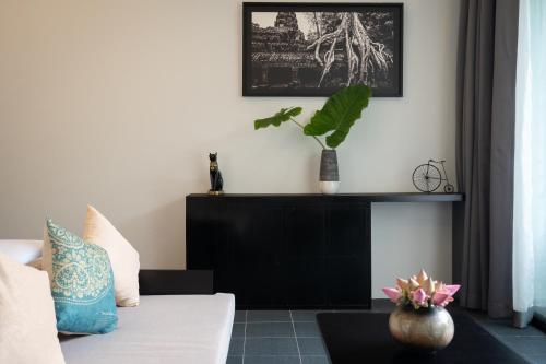 a living room with a couch and a table at Eightfold Urban Resort in Siem Reap