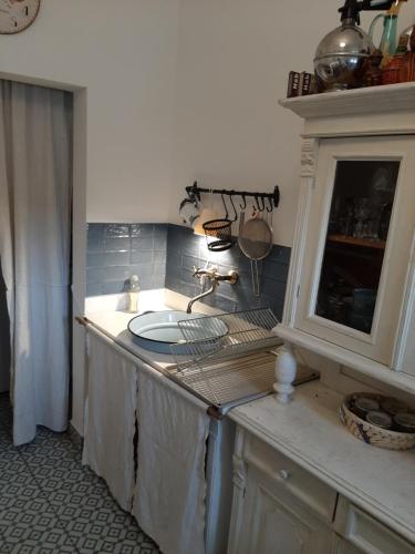 a kitchen counter with a sink and a cabinet at Fecskés Öko Vendégház Ivád 