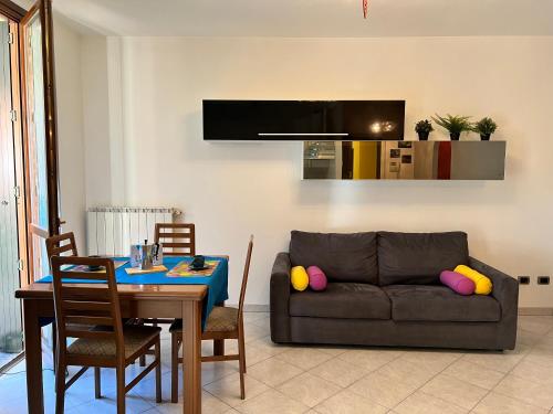 a living room with a couch and a table at Bnbook-Casa Andrea in Cardano al Campo