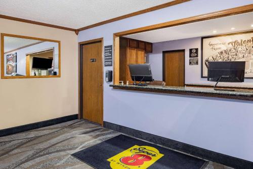 a waiting room with a counter with a monkey rug at Super 8 by Wyndham Valentine NE in Valentine