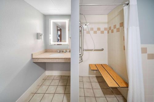 a bathroom with a sink and a shower at AmericInn by Wyndham Sayre in Sayre