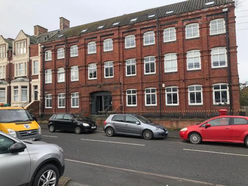 a group of cars parked in front of a brick building at 2 bedroom flat in kingswood in Bristol