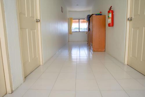 a hallway with a white tiled floor in a room at 2 Vikings Guesthouse in Karon Beach