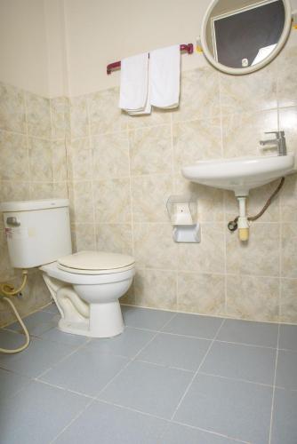 a bathroom with a toilet and a sink at 2 Vikings Guesthouse in Karon Beach