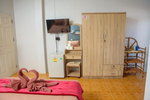 a bedroom with a bed with two flamingos on it at 2 Vikings Guesthouse in Karon Beach