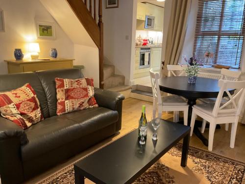 a living room with a couch and a table at Carr’s cottage Eyam Peak District, in Eyam