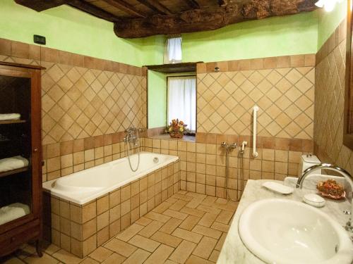 een badkamer met een bad en een wastafel bij Lush holiday home in Urbania with bubble bath in Urbania