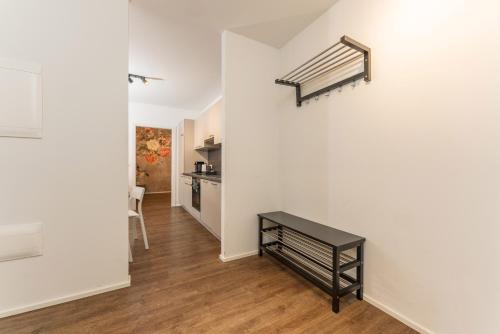 a hallway with a staircase in a white wall at APSTAY Eggenberg I Self Check-in I Parking option in Graz