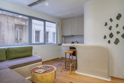 a living room with a couch and a table at LOFUS Bio-Suites in Athens