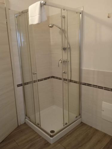 a shower with a glass door in a bathroom at Bed-Bred SELF CHECK-IN in Parma