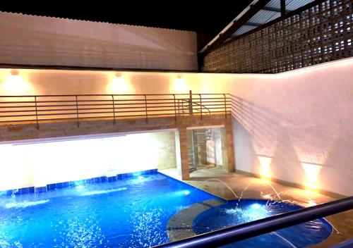 a large pool with blue water in a building at KALINA HOTEL in Girardot