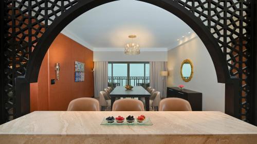 a dining room with a table and chairs at Grand Millennium Gizan in Jazan