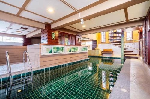 a swimming pool in a house with a swimming pool at Angel Pool Villa Phuket - SHA Extra Plus in Phuket Town