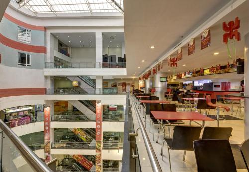 a dining area of a restaurant with tables and chairs at The Fern Residency Galaxy Mall in Āsansol