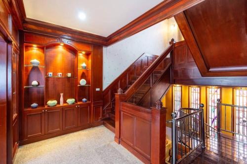 a hallway with wooden walls and a staircase in a house at Angel Pool Villa Phuket - SHA Extra Plus in Phuket Town