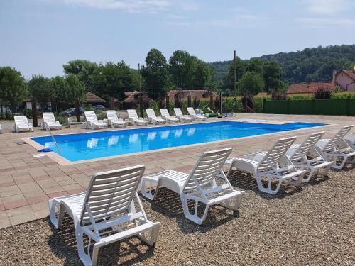 a group of lounge chairs and a swimming pool at Kumova vodenica in Markova Crkva