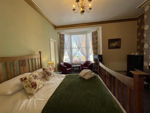 a bedroom with a bed and a chandelier at The Captain's Lodge accommodation in Whitby
