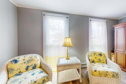 a living room with two chairs and a table at Written in the Stars in Penn Yan