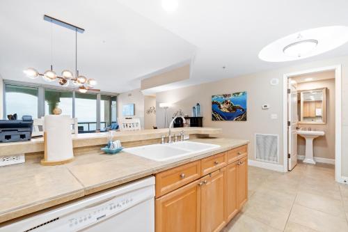 a kitchen with a sink and a counter top at Portofino Island Resort & Spa Tower Two 1306 in Pensacola Beach