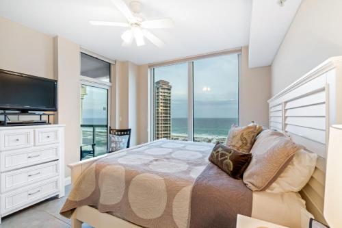 a bedroom with a bed with a view of the ocean at Portofino Island Resort & Spa Tower Two 1306 in Pensacola Beach