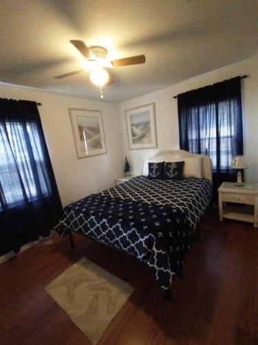 a bedroom with a bed and a ceiling fan at Beach House in Pensacola