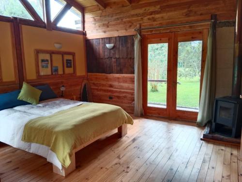 a bedroom with a bed and a tv in it at Casa parcela Frutillar in Frutillar