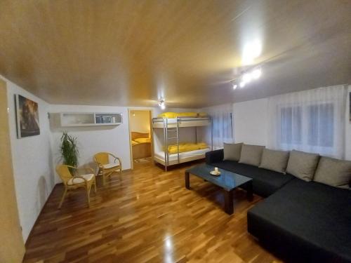 a living room with a couch and a table at Ferienwohnung an der Alfenz in Dalaas