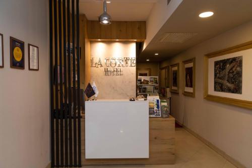 a store with a white counter in a hallway at Hotel LaCorte Prishtina in Pristina