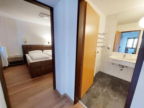 a room with a bathroom with a bed and a mirror at Bad Kleinkirchheim RMG family apartments in Bad Kleinkirchheim