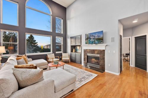 a living room with a couch and a fireplace at Family-friendly Home on Boyd Lake, Gorgeous Views! in Loveland