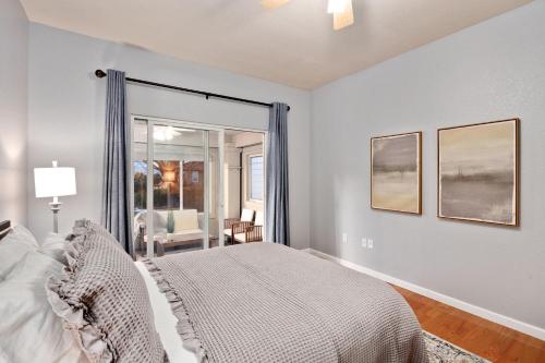 a bedroom with a bed and a large window at Family-friendly Home on Boyd Lake, Gorgeous Views! in Loveland