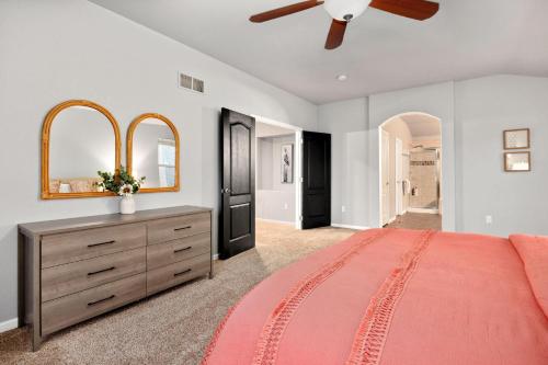 a bedroom with a bed and a dresser and a mirror at Family-friendly Home on Boyd Lake, Gorgeous Views! in Loveland